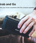 Person holding compact 12W Bluetooth Speaker With Rich Bass And Crystal Clear Sound, IPX5 Waterproof, 20 Hour Playtime, in hand
