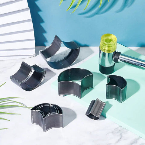 Leather Punch Die Set With 8 Fan Shaped Cutting Dies In High Carbon Steel for DIY Leather Craft displayed with mallet on table.