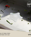 Heavy Duty Starfish Hair Catcher With Rock Solid Suction Cups For Bathtub Drains Seals Around Nasty Clogs Quick White Six Inch bathroom drain cover on countertop.