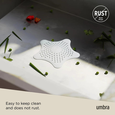 Heavy Duty Starfish Hair Catcher With Rock Solid Suction Cups For Bathtub Drains Seals Around Nasty Clogs Quick White Six Inch bathroom drain cover on countertop.