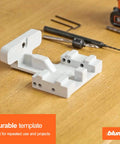 Precision drilling template for concealed undermount drawer runners that simplifies installation, with tools on wooden surface