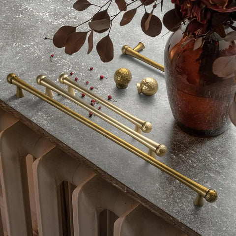 Champagne Bronze Cabinet Knobs Set 6 Pack, Modern Hammered Ball Drawer Pulls, Solid Zinc Alloy on a textured surface.