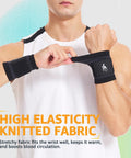 Person wearing black medium wrist brace and support wraps for workouts, shown adjusting the comfortable compression strap.