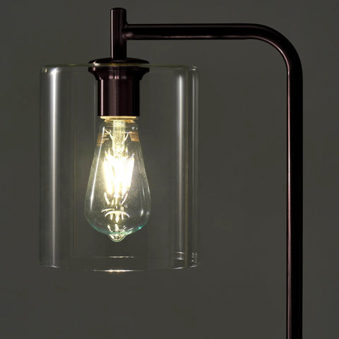 Close-up of Tall Edison Bulb Floor Lamp With Glass Shade In Bronze Finish, illuminated bulb detail, industrial vintage style