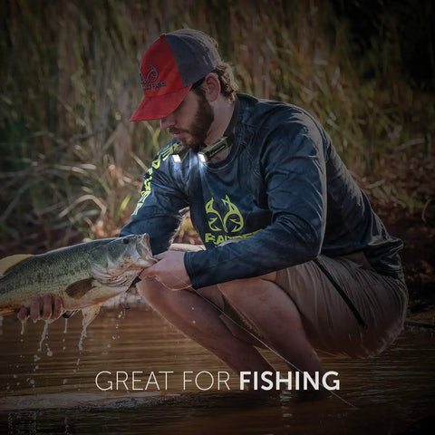 Man fishing with Real Tree 300 Lumen Hands Free Neck Light With Red And White LEDs USB Rechargeable Water Resistant Wearable Neck Lamp