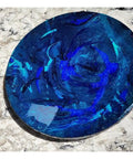 Ocean Resin And Wood Fifteen Inch Lazy Susan With Handcrafted Wave Pattern For Kitchens And Dining Tables on marble surface