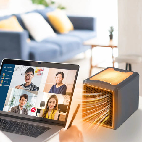 Kick Chilly To The Curb With This Compact Ceramic Space Heater, Plug Straight In At Any Wall Outlet To Blast Serious Turbo Warmth For Cozy Rooms And Offices, Keeps You Snug During Freezing Weather near a laptop during a video call.