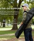 Person holding carrying case for 9 Foot Heavy Duty Portable Hammock Stand Steel Frame For Backyard Patio Or Indoor Use With Carrying Case No Hammock Included Easy Setup And Fully Adjustable Height For Tall Or Short Setups