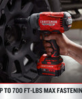 Cordless Brushless Impact Wrench Half Inch Beast Mode Power with 700 ft lbs Tightening in use on vehicle wheel