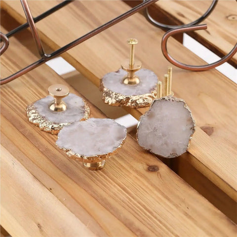 White Geode Cabinet Knobs 4 Pack Gold Plated Gemstone Drawer Pulls Crystal Cupboard Handles Kitchen Decorative Hardware Set close-up on wooden surface.