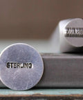 Side view of 1mm By 7mm Sterling Word Metal Punch Design Stamp C Pro Grade For Stainless Steel And Square Shank Use on bench