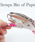 Close-up of star shaped handheld paper hole punch with soft grip pink silicone cover for crafts, 1/4 inch punch, 1.96 inch star hole.