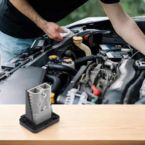 High Amperage Electric Vehicle Charging Connector Slick Fixed Base Heavy Duty Coupler Built Like A Tank For Easy Hook Ups with car engine background.
