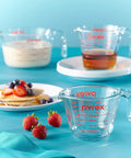 Three Piece Glass Measuring Cups Set With 1 Cup 2 Cup And 4 Cup Sizes For Prep Bake And Cook displayed with pancakes and syrup