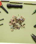 50Pcs Gold Iron Captive Nut U-Clip Fasteners for Car Bumper Grill and License Plate Mounting Heavy Duty Replacement Retainers scattered on green background.