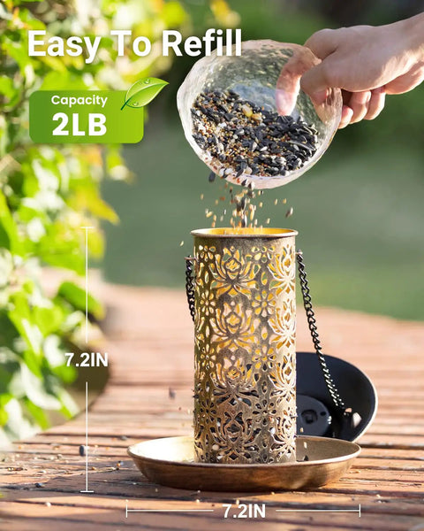 Person refilling Solar Bird Feeder For Outdoors Hanging And Garden Lantern Style Metal Wild Bird Feeder With S Hook Gift For Bird Lovers Heavy Duty Two Pound Capacity Keeps Seed Level Visible And Doubles As Night Light Yard Friendly For Cardinals