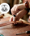 Close-up of Hardcore Stainless Steel Chicago Screw Rivets Kit With Phillips Heads being used on leather belt for crafting.