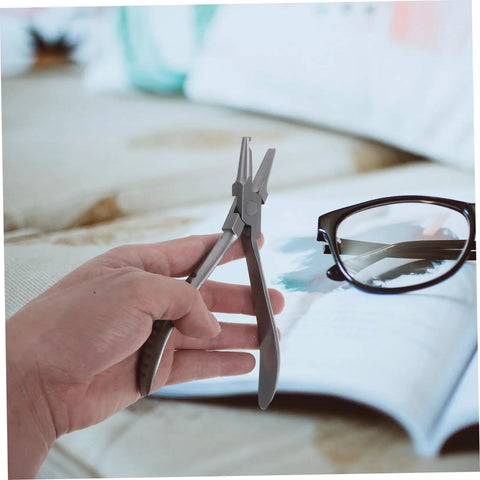 Stainless Steel Eyeglass Repair Pliers Set For Quick Nose Pad Adjustments And No Hassle At Home Fixes DIY Eyewear Maintenance Kit With Pro Grade Tools For Safe Easy Frame Repairs, held in hand with glasses nearby.