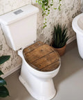 Round Overhead view brown wooden table Toilet Seat on a white toilet in a stylish bathroom setting with plants.