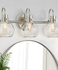 3 Bulb Brushed Nickel Wall Sconce With Clear Globe Glass Shade Totally Straight Fire Farmhouse Lighting Fixture For Bathroom Mirror And Kitchen E26 Socket Base Legit on a wall above a mirror.