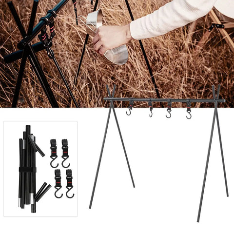 Ultra Portable Triangular Outdoor Storage Rack For Camping And Picnics set up with cookware hanger and accessories on grass