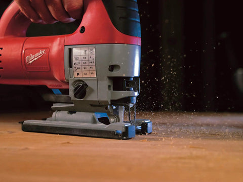 Close-up of Top Notch 6.2 Amp Orbital Jig Saw Boasting Tool Free Blade Swap and Seven Setting Speed Dial cutting wood.