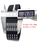 Digital caliper measuring black rubber belt with white text, showing dimensions of 34.14 mm and 1.34 inches in height.