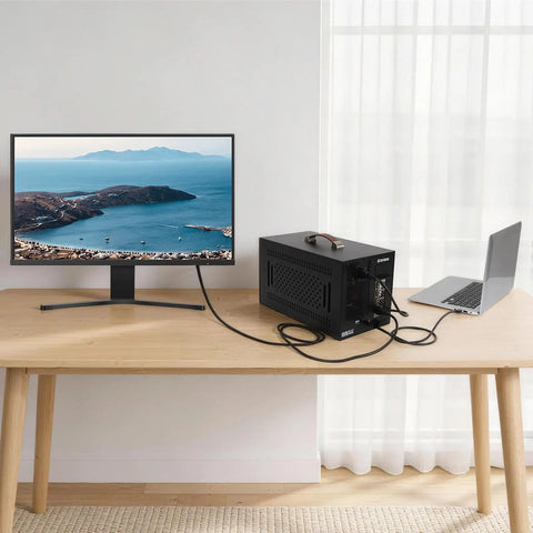 Beefy Thunderbolt 3 External Graphics Dock Paired With 750W Power Supply connected to a laptop and monitor on a wooden desk.