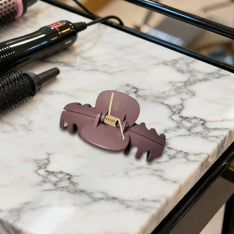 8 Pack Hair Clip Spring Replacement with strong clamping steel jaw clip on marble counter next to hair tools