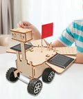 Child playing with Solar Powered Mars Rover Kit Made Of Wood For DIY Engineers A Dope Educational STEM Project