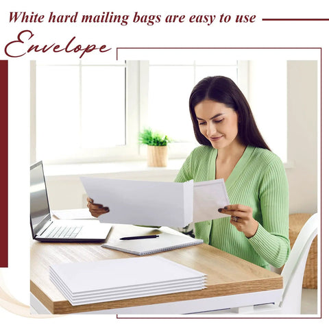 Person using 50 Pack Bulk Large Rigid Mailers 13 x 17.75 Inch Self Seal Cardboard Envelopes at home office desk