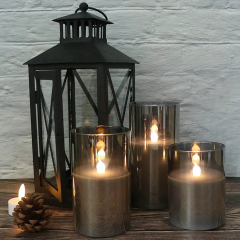 Gray Glass Flameless LED Candles Battery Powered With Timer And 10 Key Remote Real Wax Warm Flicker For Weddings Parties Holidays And Cozy Home Decor Vibes Set Of 3 next to black lantern.