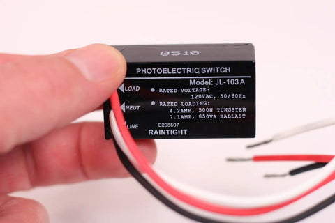 Close-up of Two Pack Outdoor Dusk To Dawn Light Sensor Controllers showing wiring and specifications label for home safety.