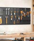 Heavy Duty Metal Pegboard Panels 3 Pack For Garage Wall Organization And Tool Storage, Modular Peg Board Organizer For Workbench, Powder Coated Steel Panels In Black installed in workshop with tools.