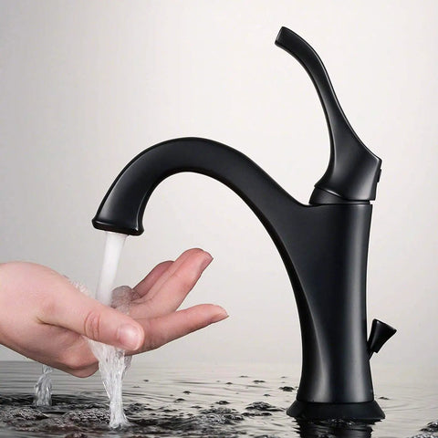 Arlo KVF-1200MB Dope Matte Black Single Handle Vessel Bathroom Faucet With Pop Up Drain in use with running water over hand.