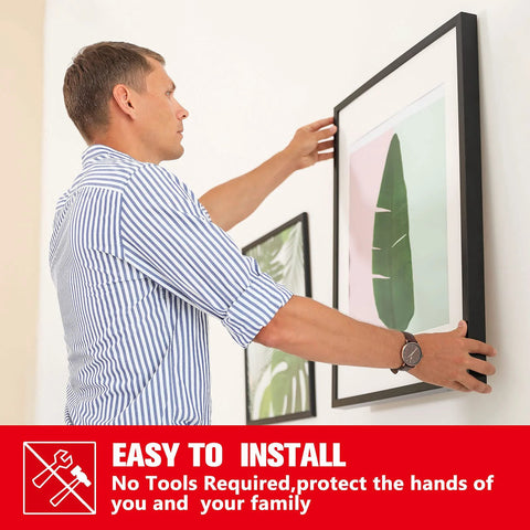 Double-sided mounting tape used to hang a framed picture on a wall