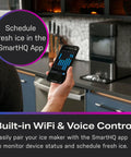 Person using smartphone app to connect with Countertop Nugget Ice Maker With WiFi Connectivity For Smart Home Kitchens Fast Chewy Ice On Tap Black Stainless Finish Compact Ice Machine Perfect For Drinks And Entertaining
