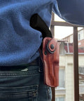 Person wearing OWB Leather Paddle Revolver Holster With Retention Strap For Pietta 1858 Ace Black Powder 44 Cal 3 Inch