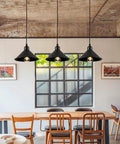Heavy Duty Black Plug In Pendant Lights 2 Pack Industrial Hanging Lamps With 15 Foot Adjustable Cord And Switch over a dining table.
