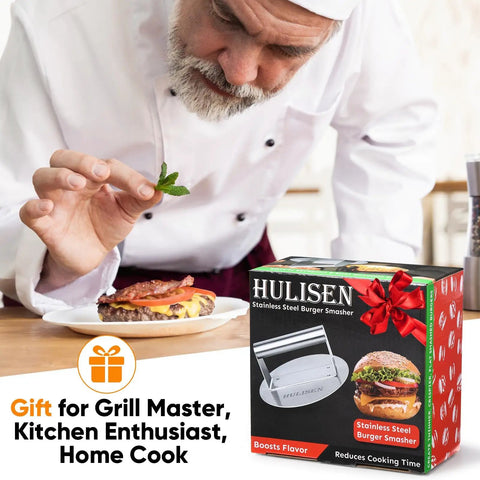 Chef using Stainless Steel Burger Press Round 6.2 Inch Smasher box near a plated burger, ideal for griddles and grills.