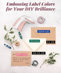 Vintage Embossing Label Maker With Six Adhesive Tape Rolls Manual Typewriter Style Sticker Gun on a flat lay with colored labels.