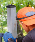 Installer measuring a post with Aluminum Pyramid Post Caps For 4x4 Wood Posts Black Outdoor Deck Fence Post Cap With Screws