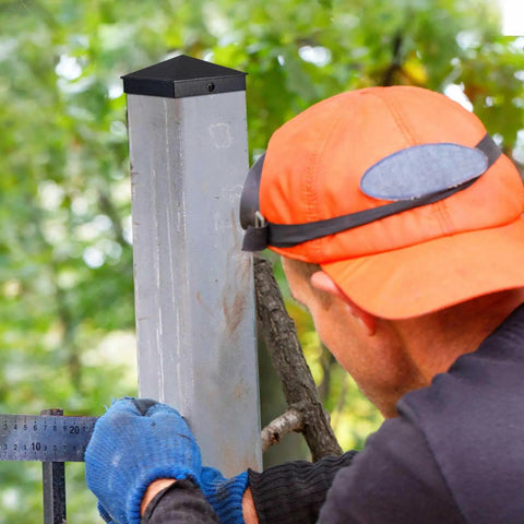 Installer measuring a post with Aluminum Pyramid Post Caps For 4x4 Wood Posts Black Outdoor Deck Fence Post Cap With Screws