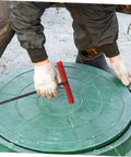 Heavy Duty Multi Function Manhole Cover Lifter With Thick T Shaped Handle For Roller Shutters And Sliding Doors Top Notch No Sweat Pulling Tool Set Pro Grade in use to lift a green drainage cover.