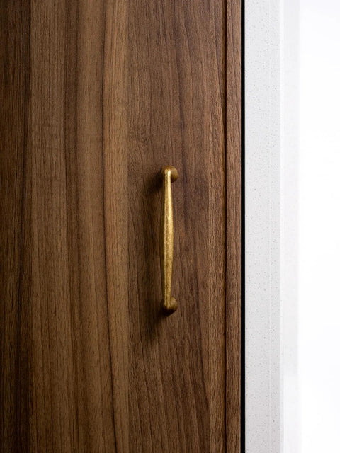 Antique Brass Zinc Alloy Cabinet Pulls With Three And Three Quarter Inch Hole Centers installed on wooden cabinet door