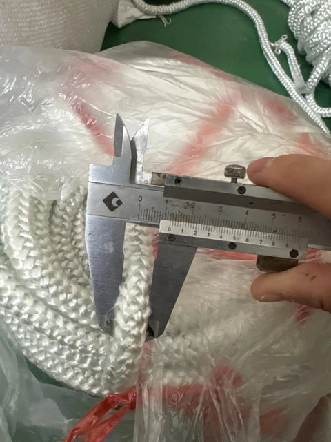 Graphite Impregnated Fiberglass Rope Seal Gasket For Wood Stoves 14mm By 2m in white with caliper measurement tool