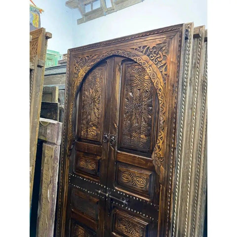 Hand Carved Barn Door With Brown Gold Finish Dope Look And Custom Size For Interior Exterior Use Double Or Single Sliding Or Hinged Front Door Antique And Modern Style Made To Order visible, showcasing intricate carvings.