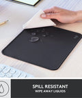 Studio Series Mouse Pad With Anti Slip Rubber Base, Spill Resistant Surface, Easy Gliding, Durable Materials, Portable Desk Mat In Graphite, Fresh Modern Design For Home Office And Gaming, shown repelling water on wooden desk