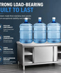 Gutsy No Nonsense Stainless Steel Workbench With Double Sliding Doors Heavy Duty Prep Table with three water bottles on top.