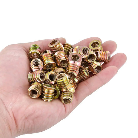 Hand holding 60 Pcs 5/16-18 Threaded Wood Inserts For Furniture And Cabinets, Nut And Bolt Inserts For Woodworking Projects, Heavy Duty And Easy Install